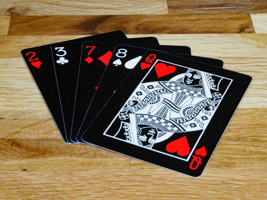 four of a kind of playing cards on a table.