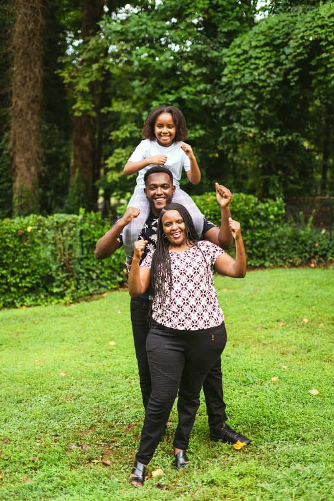 a family posing for a photo in the park.