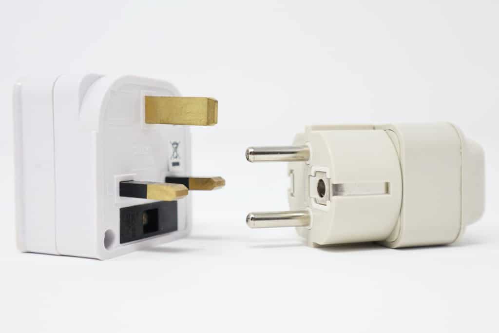 a white plug with a gold plug next to it.