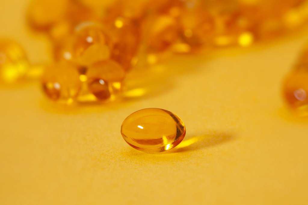 a drop of oil on a yellow surface.