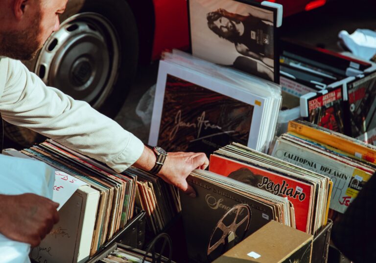 A man buying records at a flea market.