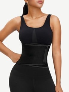 A woman wearing a black waist shaper.