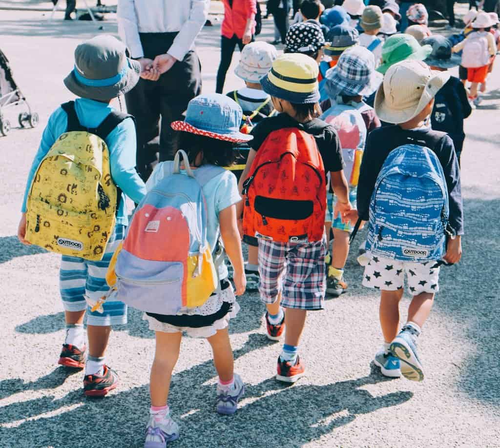 A group of children walking down the street.