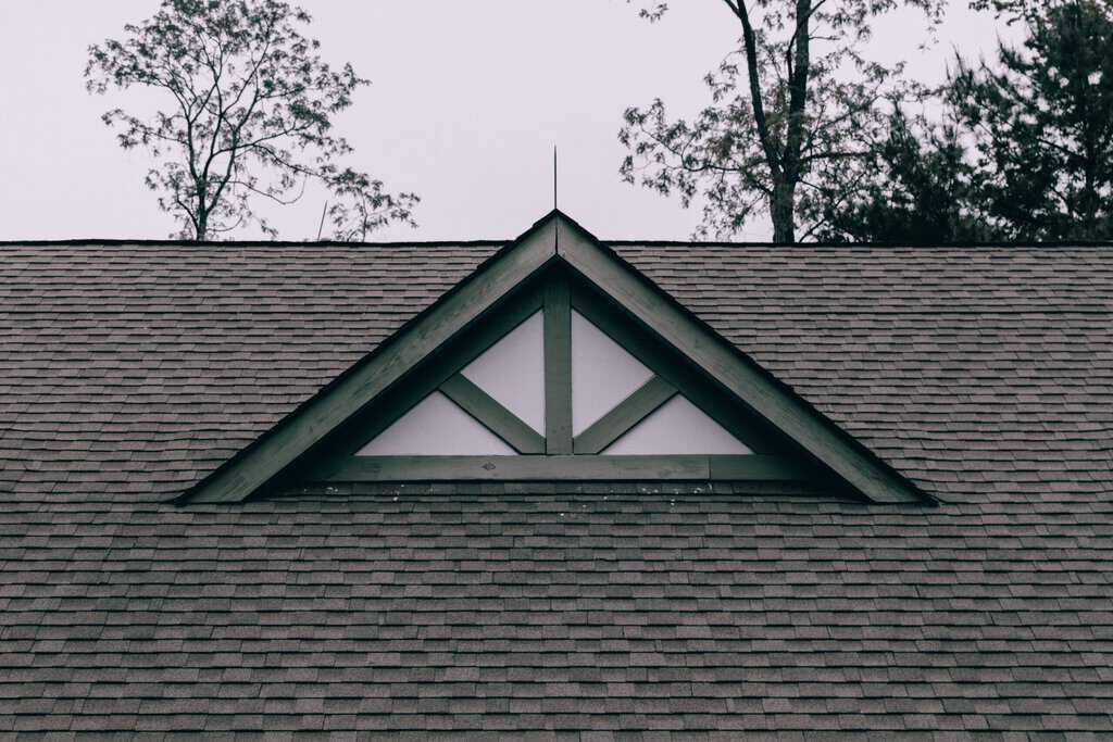 A roof with a triangular window on it.