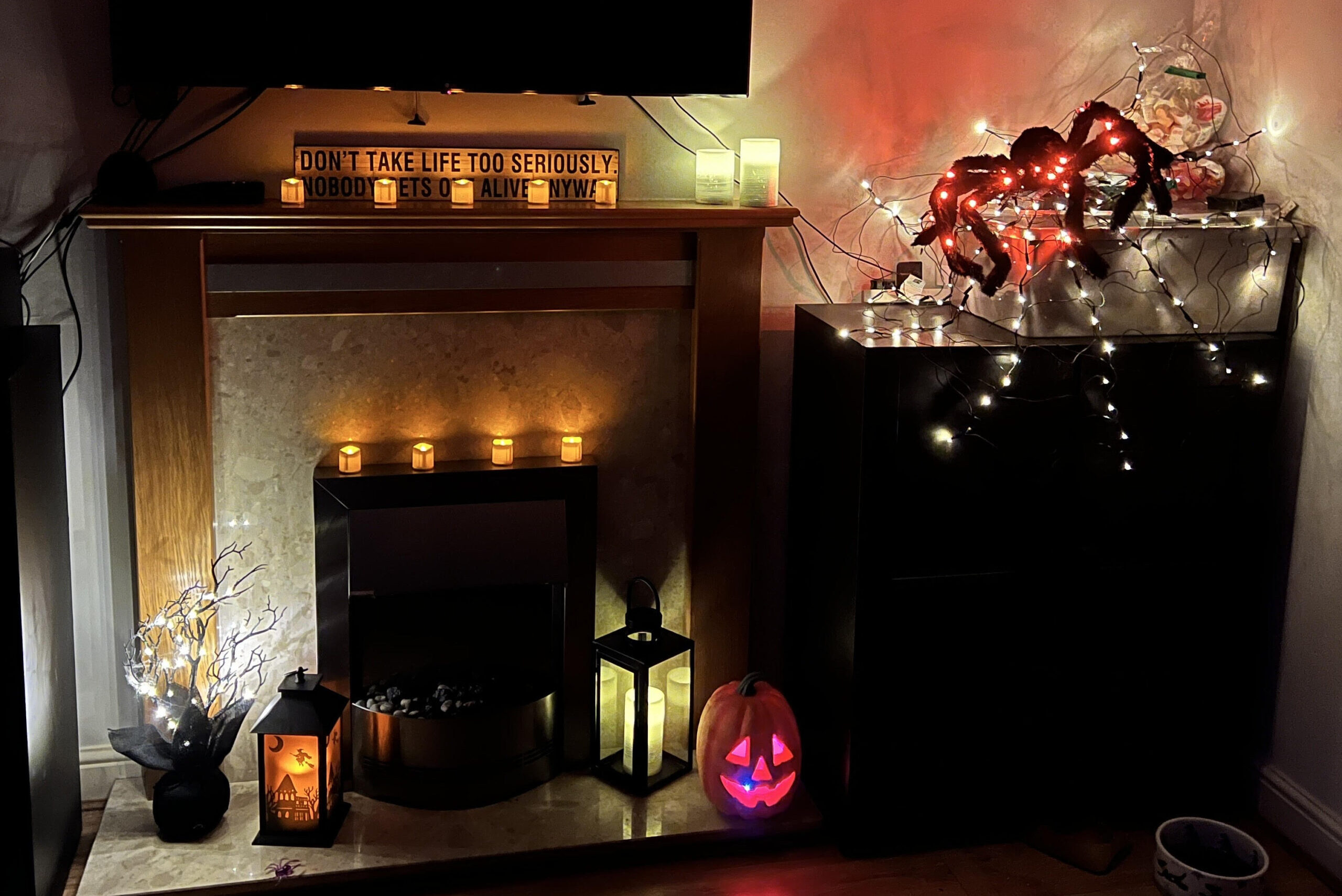 Transform your living room into a cozy and inviting space with a modern fireplace and a sleek TV, perfect for enhancing your Halloween home décor. Add an extra touch of ambiance with Light4Fun's